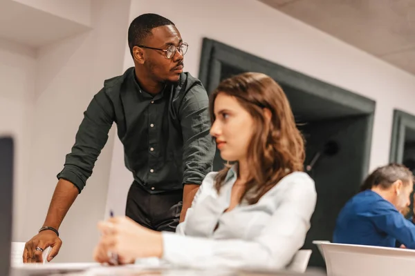 Black Male Manager Looking Something While Working His Female Coworkers — Stock Photo, Image