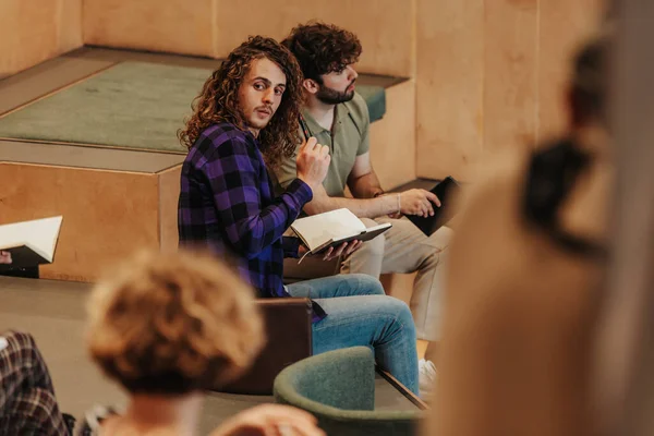 Young Faculty Student Looking Back Writing His Notebook Lecture — Stock Photo, Image