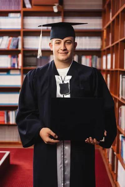 Young Happy Graduate Wearing Cap Gown Holding His Bachelor Degree — Stock Photo, Image