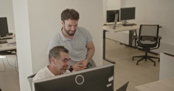 相机放大了年轻和年长的男同事一起工作的一个项目和微笑 积极的办公室工作概念 — 图库视频影像