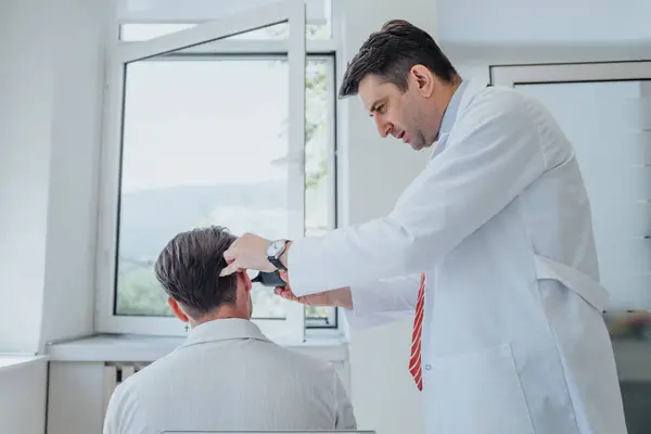 In a clinic, doctors check eyesight, hearing, and throat on a senior patient. Cleaning ears, diagnosis, successful therapy, and treatment provided by specialists.