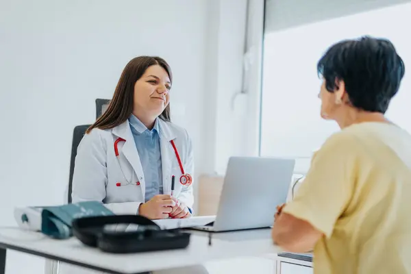 An experienced doctor provides professional care to an elderly patient. Diagnosis is analyzed and results are discussed. A positive and satisfying consultation takes place.