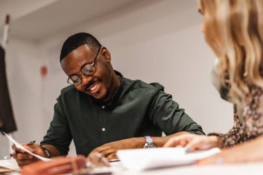 Happy, smiley, satisfied male manager reading positive statistics and reports. clipart