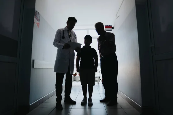 Silhouette of Experienced Doctors Discussing Diagnosis and Successful Treatment Options for Child Patients