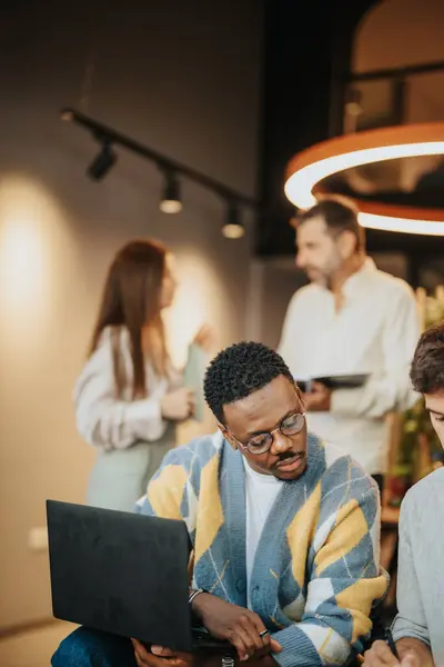 Employees discuss new opportunities and analyze market statistics in a modern co-work space. They collaborate, working together towards increased productivity and successful trading strategies.
