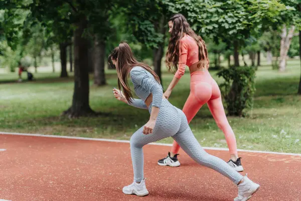 Active Fit Girls Enjoying Outdoor Sport Routine in Urban Park