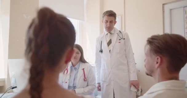 Unga Par Konsulterar Medicinska Specialister Deras Hälsa Läkare Som Ger — Stockvideo