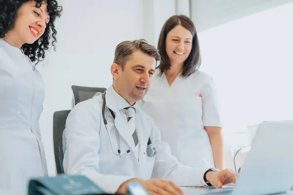 Doctor and nurses discussing diagnostic test results, providing consultation and explaining health problems. Cardiogram tests and radiology findings reviewed for accurate diagnosis and treatment.