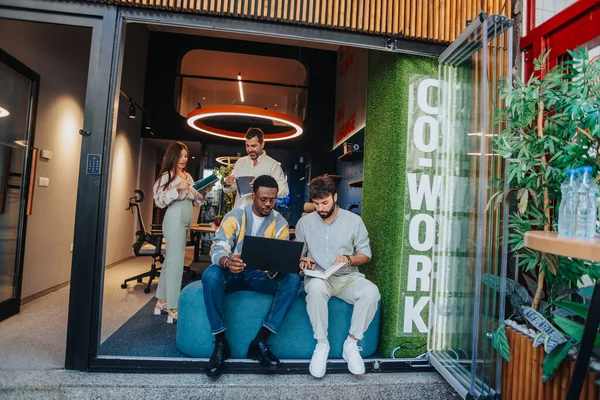 Diverse entrepreneurs collaborating in a creative co-working space, solving problems and working on new projects. Together, they showcase the power of teamwork in a modern workplace.