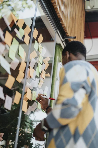 多种族同事在一个玻璃板上头脑风暴 分享想法和规划一个成功的项目 在这种现代办公环境下 团队合作是显而易见的 — 图库照片