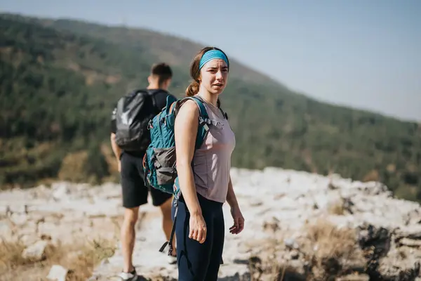 An athletic people explores the fresh air and green environment, hiking and enjoying a sunny day. Perfect for adventure travel or weekend recreation in the natural wilderness.