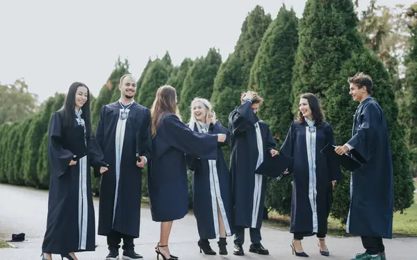 Diverse University Students Graduation Gowns Celebrate Success Sunny Park Throwing — Stock Photo, Image