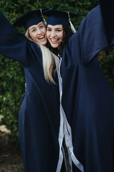 Multiethnic University Girls Graduation Uniforms Celebrate Success Hugging Each Other — Stock Photo, Image
