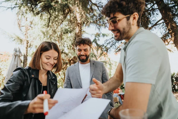 Business people gather outdoors in a city, discussing work and strategizing for business growth. They analyze budget, collaborate on marketing, and plan project costs for successful expansion.