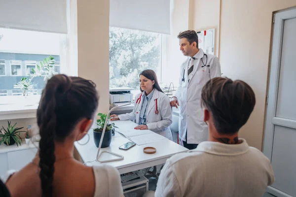 Specialist discusses treatment options with a patient in a clinic. Analysis of x-rays and lab results aids accurate diagnosis. Professionals provide expert care and solutions for health problems.