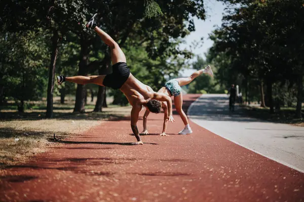 Fitness Couple Performing Cartwheels Park Displaying Athleticism Motivation Natural Environment — Stock Photo, Image