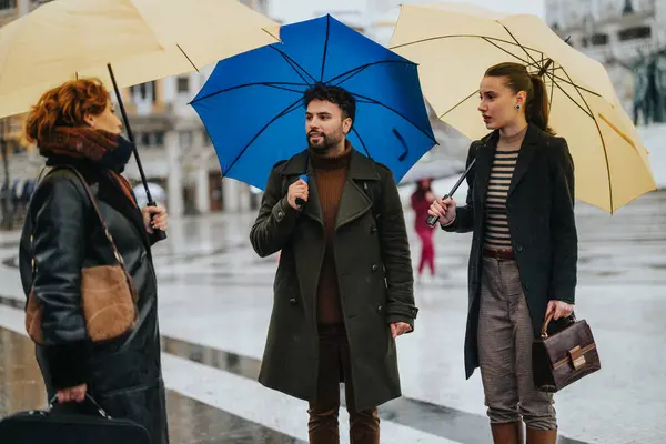 A group of business people discussing project development and market expansion under umbrellas in the rain. They prioritize sustainable business growth, teamwork, and innovation.