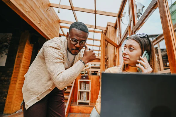 Diverse businesspeople brainstorm over coffee in urban setting, discussing collaboration, financial planning, growth hacking, market analysis, and scalability with multiracial executives.