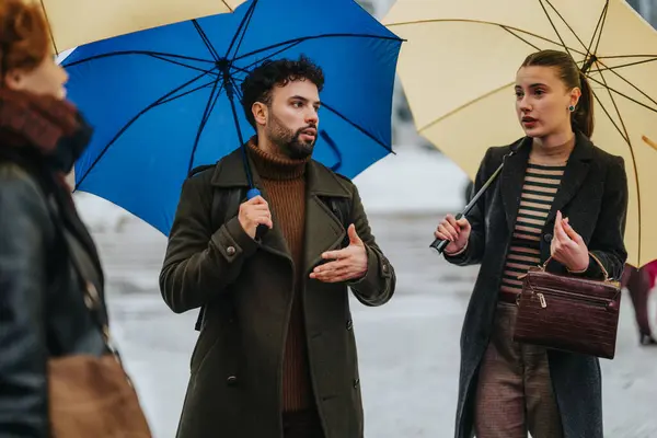 Young Business Partners Discussing Project Statistics Details Rainy City Umbrellas — Stock Photo, Image