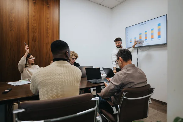 Colleagues in a boardroom meeting, discussing ideas, analyzing statistics for business growth, profitability, and success.