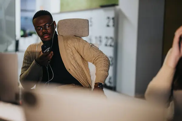 Good looking, black man watching tutorial before to keep solving project tasks at work.