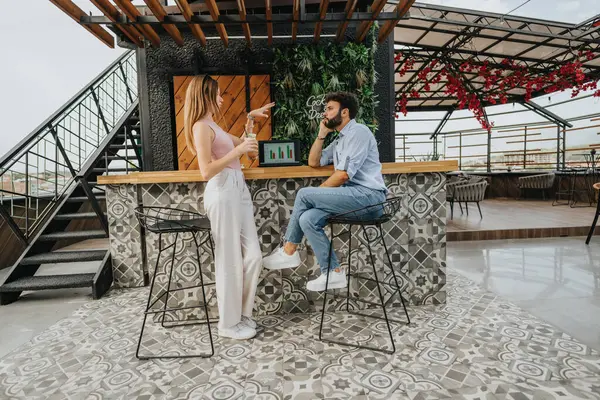 Young business couple meets in an urban cafe to discuss expanding their growing company. Brimming with new project ideas, theyre committed to maximizing profit.