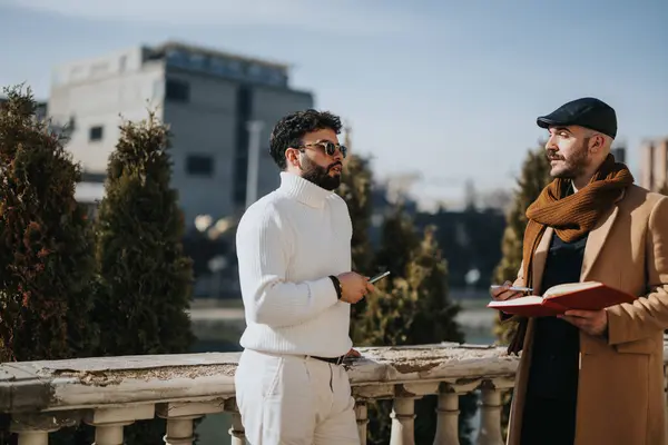 Fashionably Dressed Men Having Serious Discussion Balcony Cityscape Background Warm — Stock Photo, Image