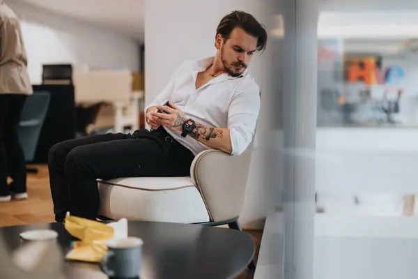 Pensive Young Man Tattoos Sits Stylish Office Lounge Looking His — Stock Photo, Image