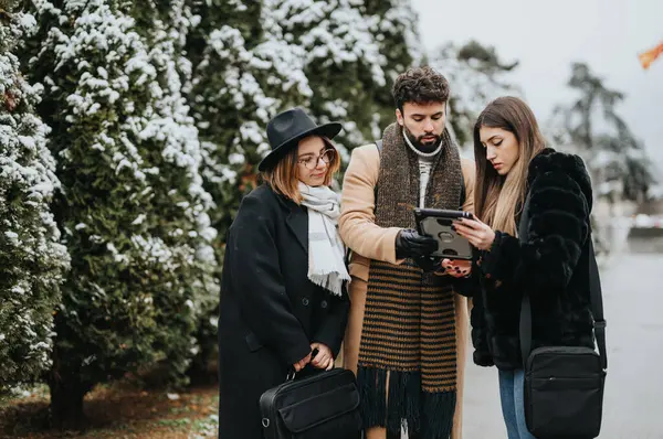 Three Fashionable Friends Share Moment Looking Tablet Snowy Day Embodying — Stock Photo, Image