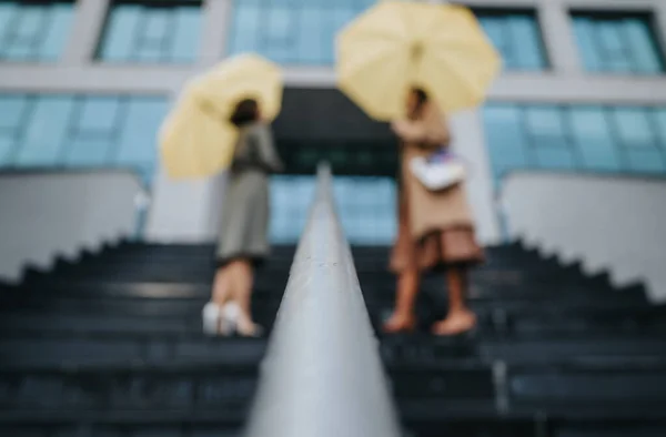 Artistic Blur Showcases Two Individuals Yellow Umbrellas Steps Evoking Urban — Stock Photo, Image