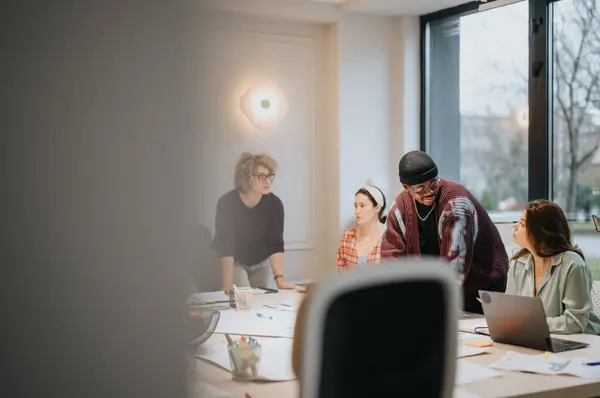 Multi Ethnic Group People Collaborates Laptop Well Lit Contemporary Workspace — Stock Photo, Image