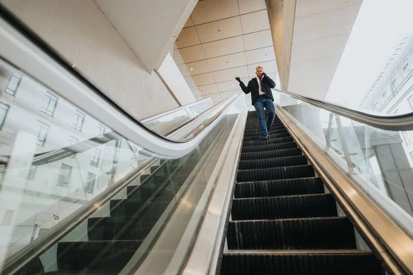 商人在一个现代的 通风的公司大楼内的自动扶梯下 体现了效率和城市生活方式 — 图库照片