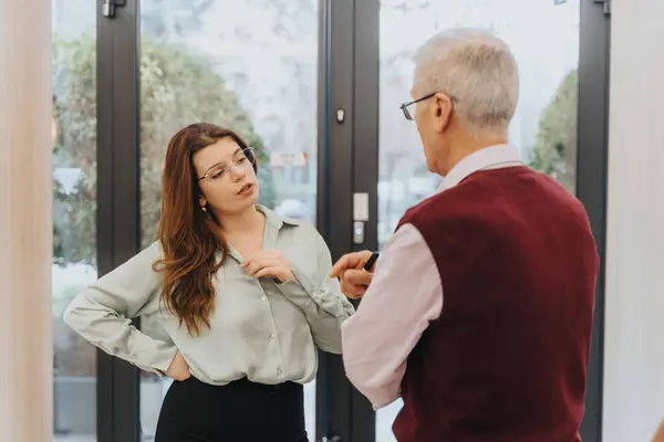 Two Different Aged People Coworkers Engage Conversation Office Doorway Woman — Stock Photo, Image