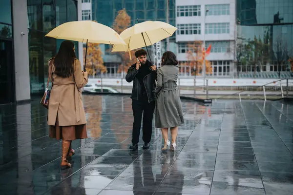 Urban people sharing yellow umbrellas on a rainy city street.