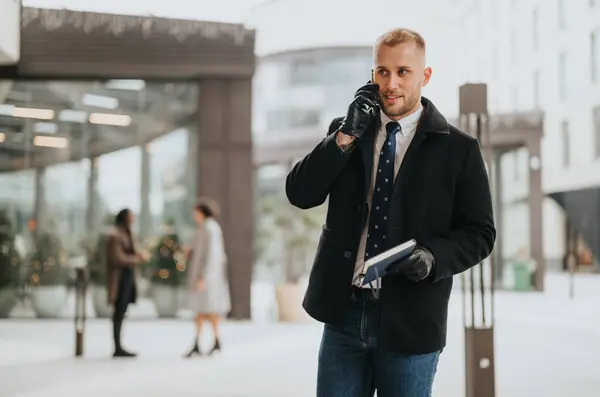 Professional man talking on phone in urban setting during festive season.