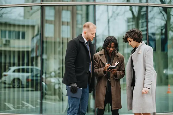 Three Business Colleagues Engaged Discussion Outdoors Using Notebook Modern Urban — Stock Photo, Image
