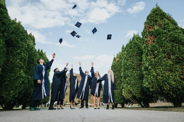 Graduates Throwing Caps Park Celebrating Achievements Classmates Faculty Smiling Faces — Stock Photo, Image