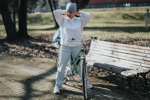 Active Woman Casual Attire Prepares Bike Ride Park Adjusting Her — Stock Photo, Image