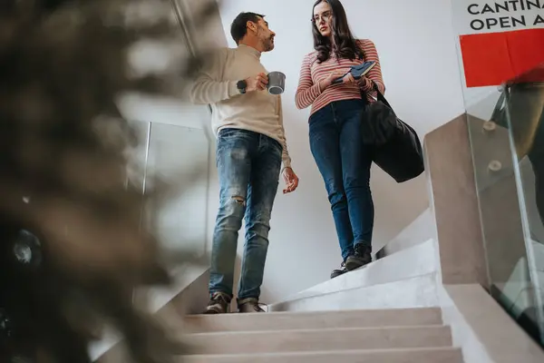 Two Coworkers Engage Casual Conversation While Walking Stairs Office Setting — Stock Photo, Image