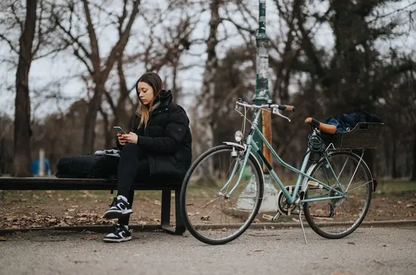 Ung Kvinna Med Hjälp Smart Telefon Parkbänk Bredvid Vintage Cykel — Stockfoto