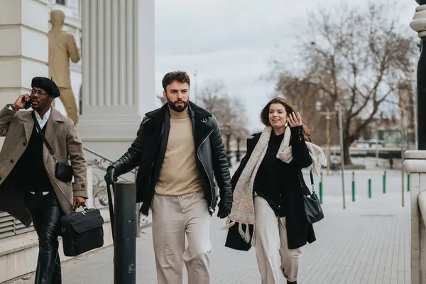 Stylish business people stroll along a city sidewalk, engaged in conversation. Urban life and contemporary fashion blend seamlessly in this candid moment.