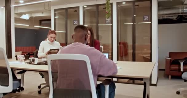 Two Colleagues Stand Collaborate Using Laptop Bustling Contemporary Office Environment — Stock Video