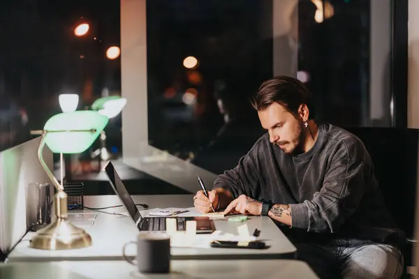 Dedicated Man Focuses Writing Notes His Desk Office Night Time — Stock Photo, Image