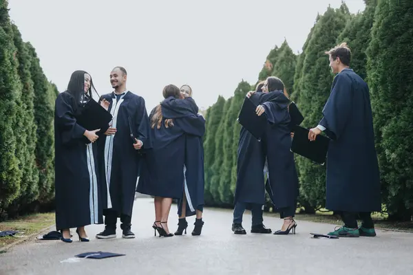 University Students Graduation Gowns Caps Celebrate Success Sunny Park Walk — Stock Photo, Image