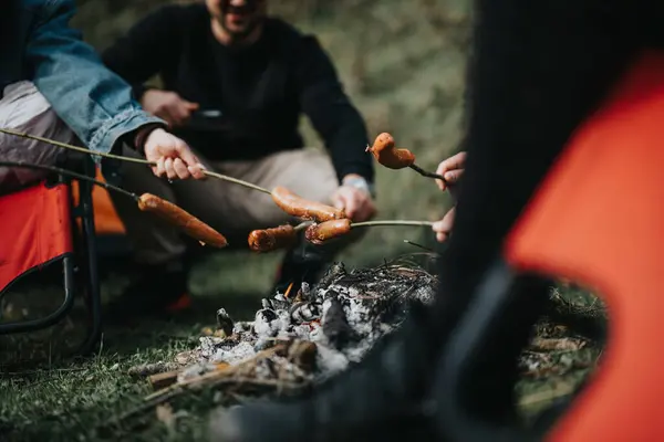 Group of friends gathered around a campfire, roasting sausages on a cool evening, sharing stories and laughter.