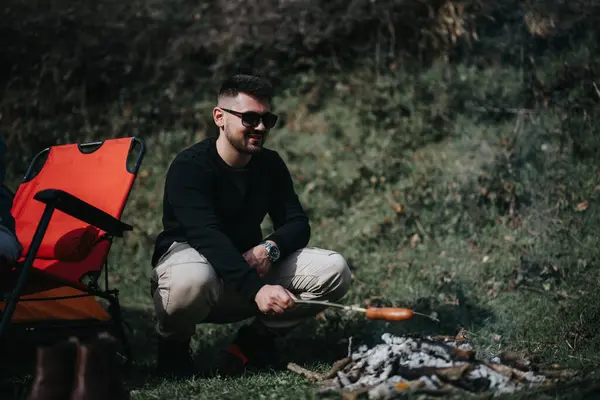 Gündelik Giysiler Içinde Gülümseyen Bir Adam Kamp Ateşinde Kavrulmuş Yiyecekler — Stok fotoğraf