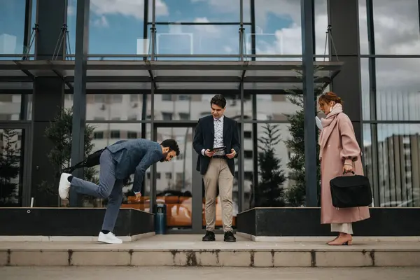 Young Male Business Person Stumbling While Walking Sidewalk His Colleagues — Stock Photo, Image