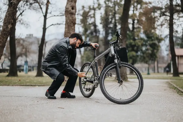 A business entrepreneur in formal attire checking his bike outdoors, showcasing a blend of professionalism and an active lifestyle.
