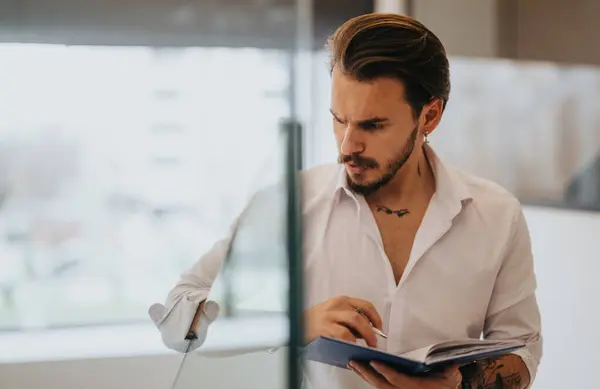 Focused Young Entrepreneur Reviewing Documents Modern Office Space — Stock Photo, Image