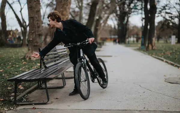 stock image Active lifestyle captured with a young man enjoying a bike ride in a scenic park during fall.